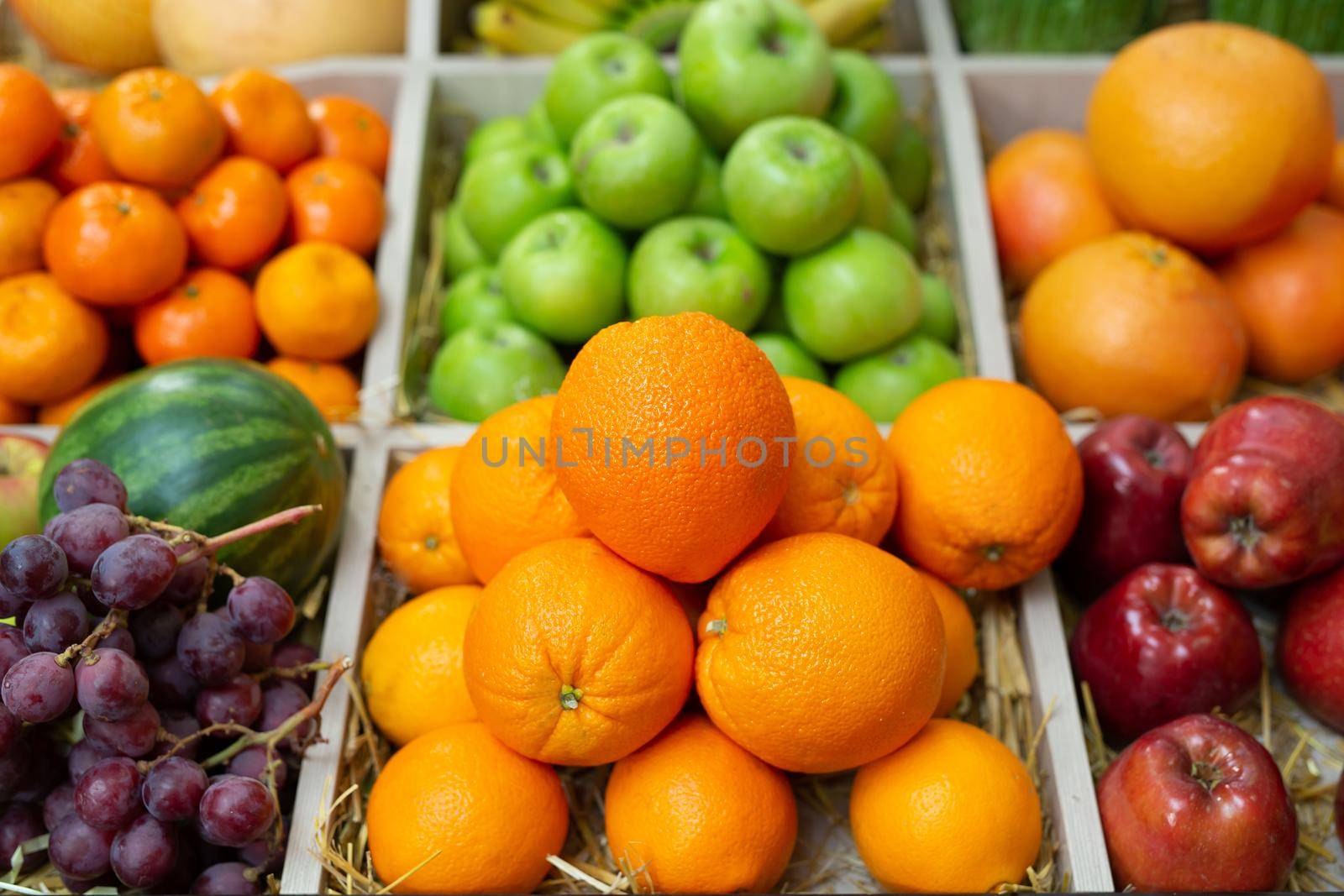 Fruits: orange, banana, apple watermelon grapes on the counter of the store