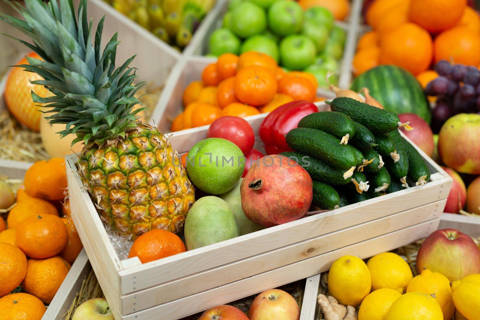 Wooden box with vegetables and fruits on the counter of the store.