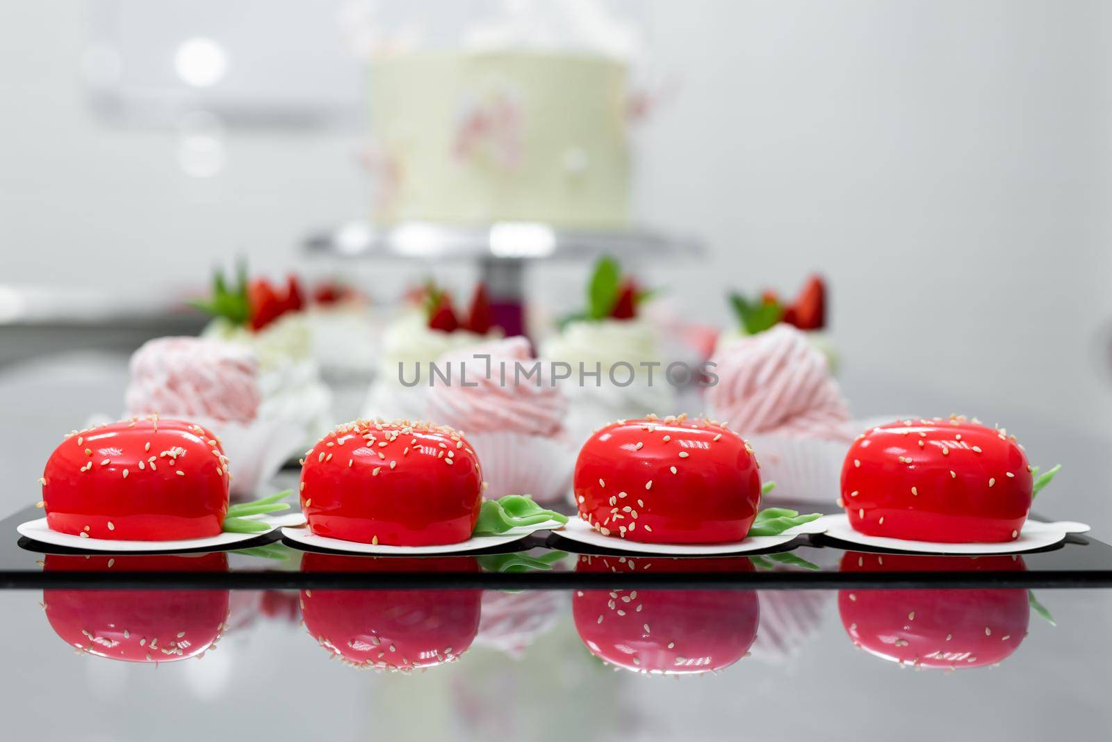 Pavlova meringue, marshmallows and mousse cake on the table in the pastry shop.