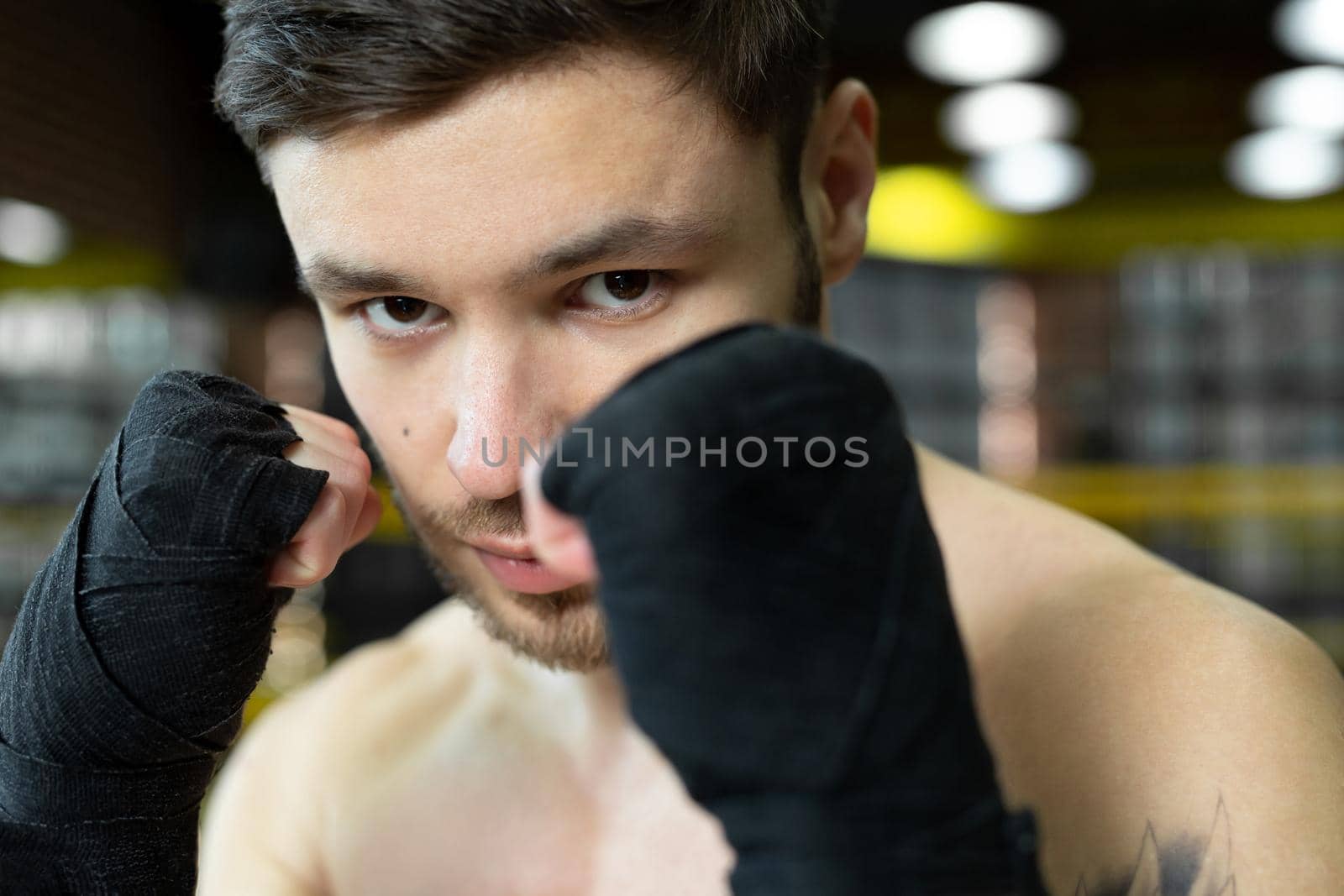 Portrait of a boxer with bandages on his hands. The concept of sport.
