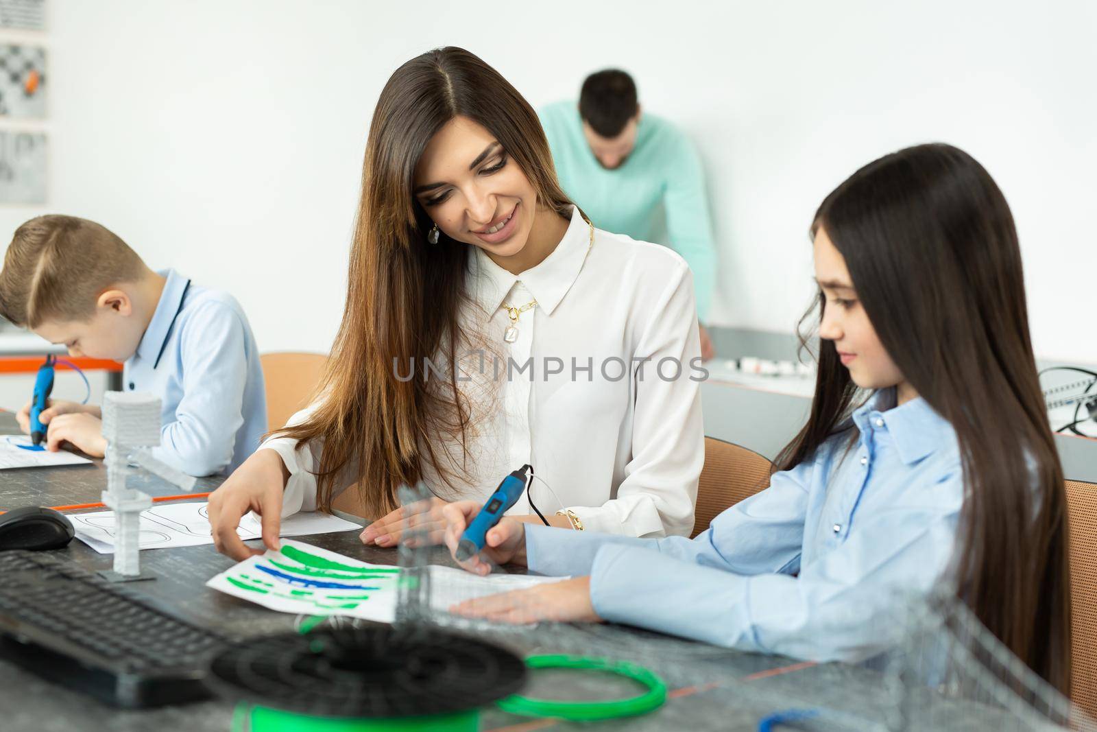 Lesson in the robotics hall. Mom and daughter use pen for 3D printing. Creative, technology, leisure, educational concept. by StudioPeace