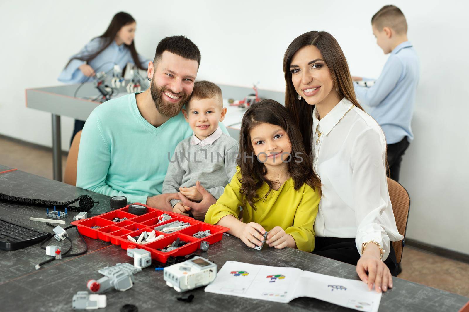 Family with children in a robotics club makes a robot controlled from a constructor by StudioPeace