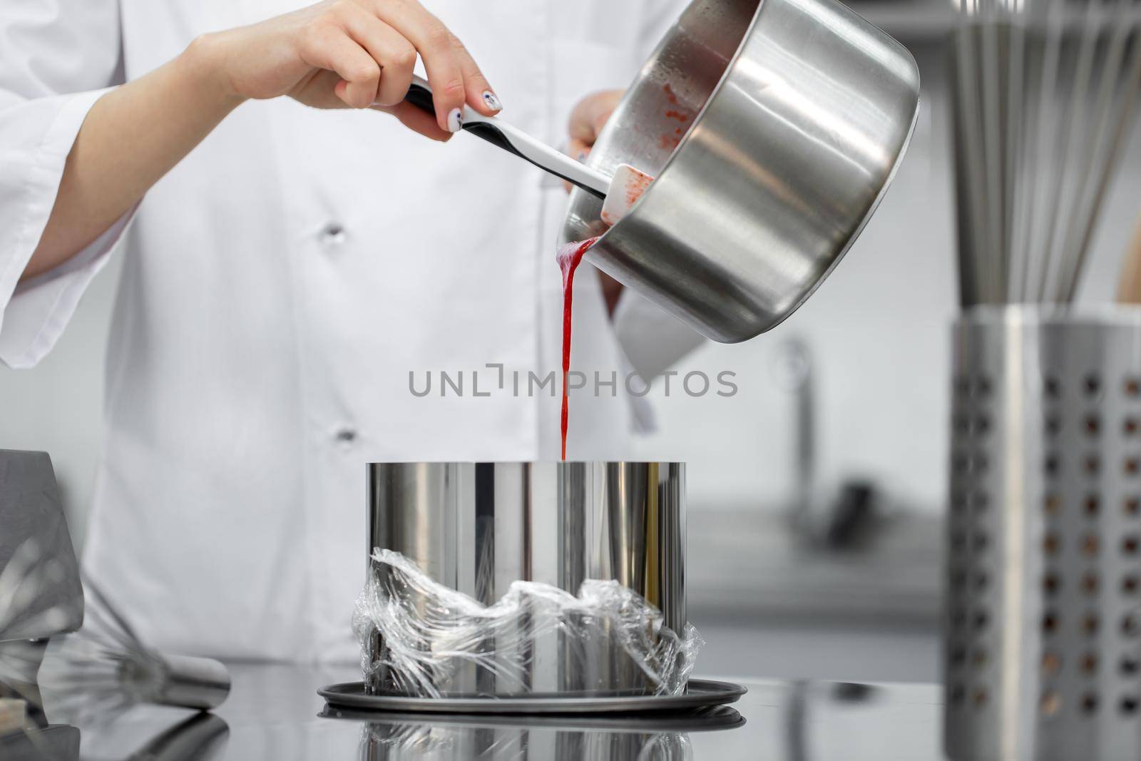 Pastry chef pours the cake filling into a round shape by StudioPeace