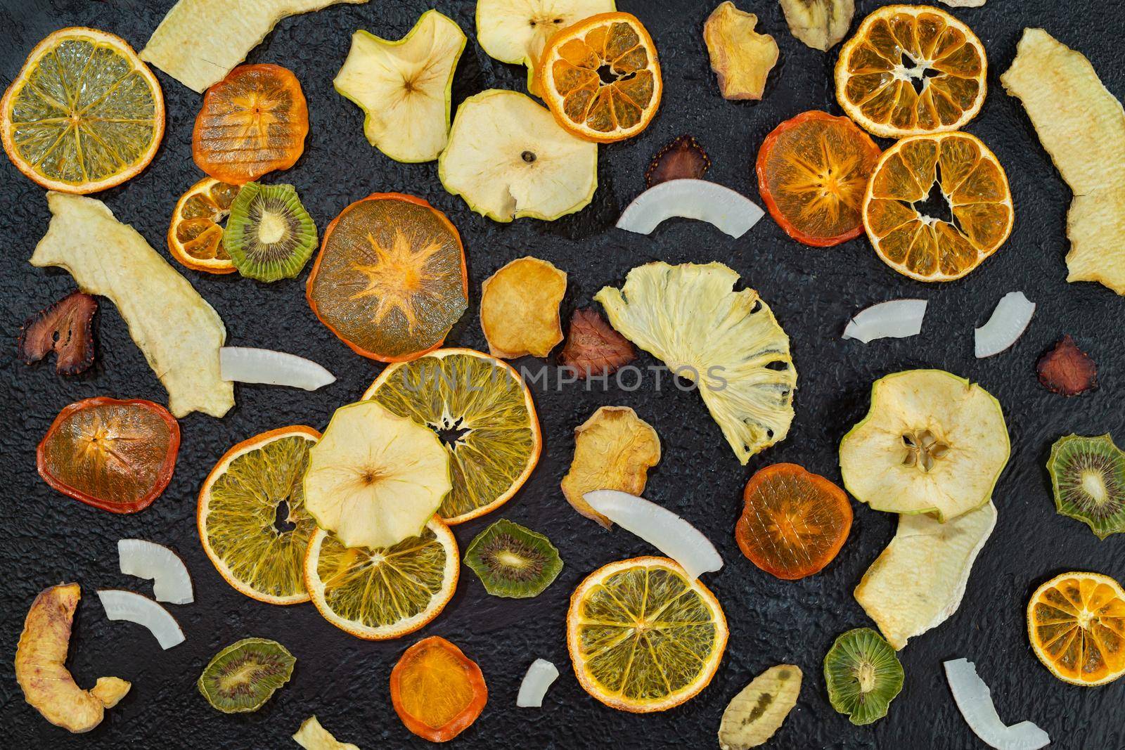 Organic Healthy Assorted Dried Fruit Close-up. Snacks from fraps: apple, pear, orange, banana, persimmon, coconut pineapple strawberry