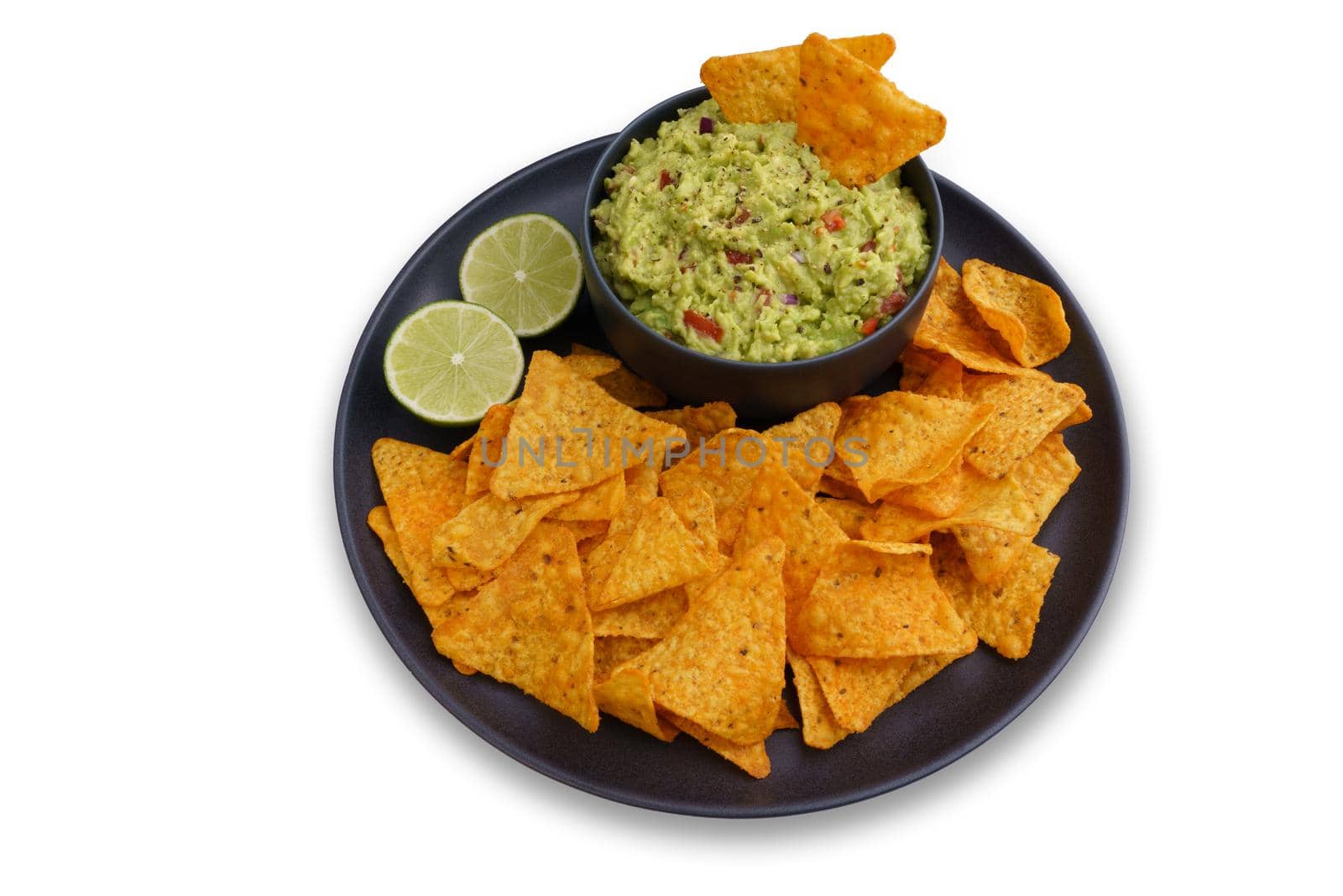 Top view of guacamole sauce and tortilla chips or nachos in black plate isolated on a white background. High quality photo