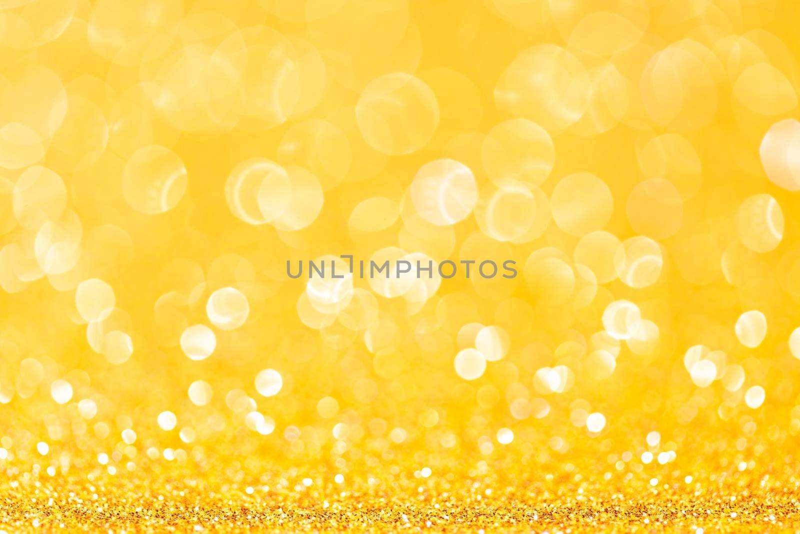 sparkles of yellow glitter abstract background. Copy space.