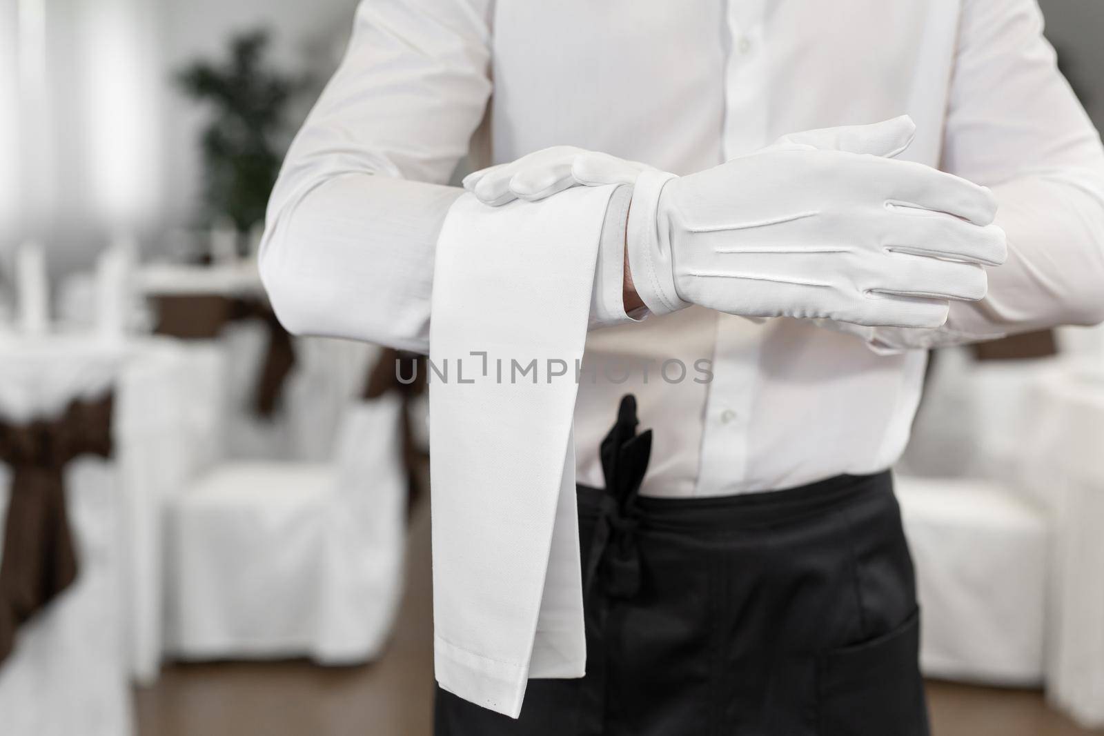 Close-up of the waiter's hand with a towel by StudioPeace