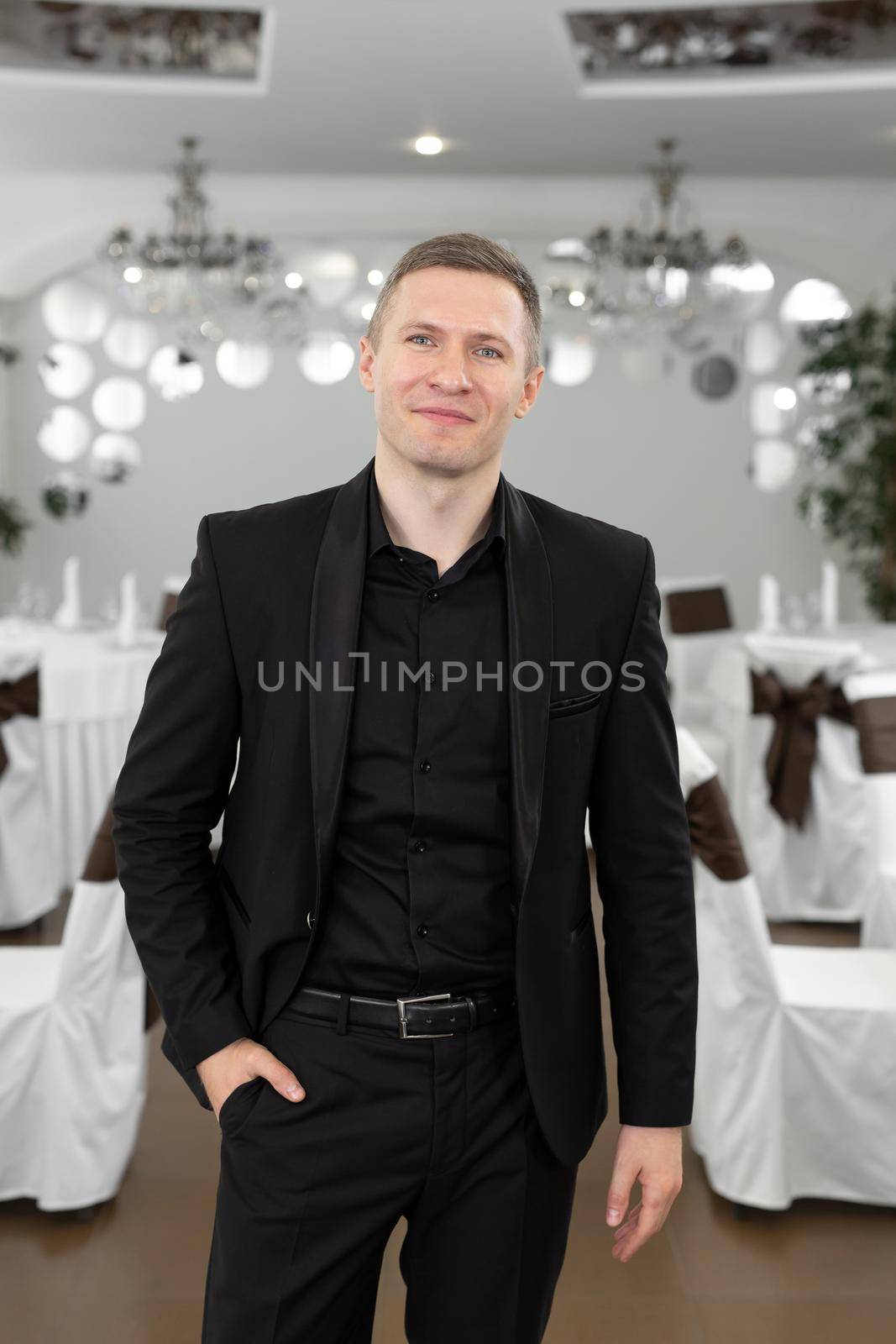 Handsome young man in a suit in a restaurant.