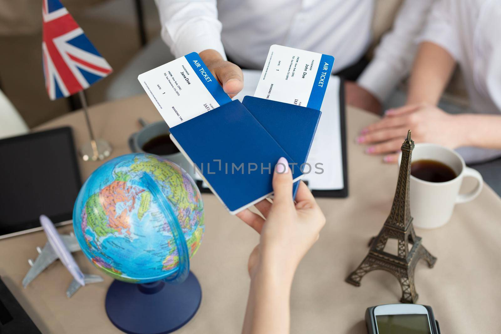 Close-up of passports and tickets in the hands of a travel agent in the office.