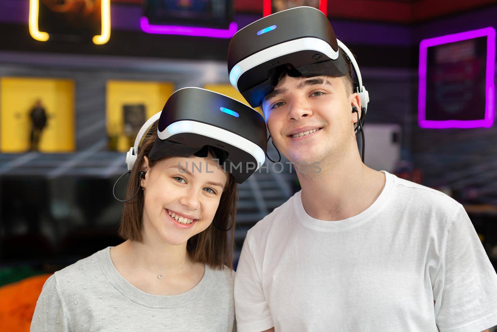 Portrait of teenage friends, a boy and a girl in virtual reality glasses.