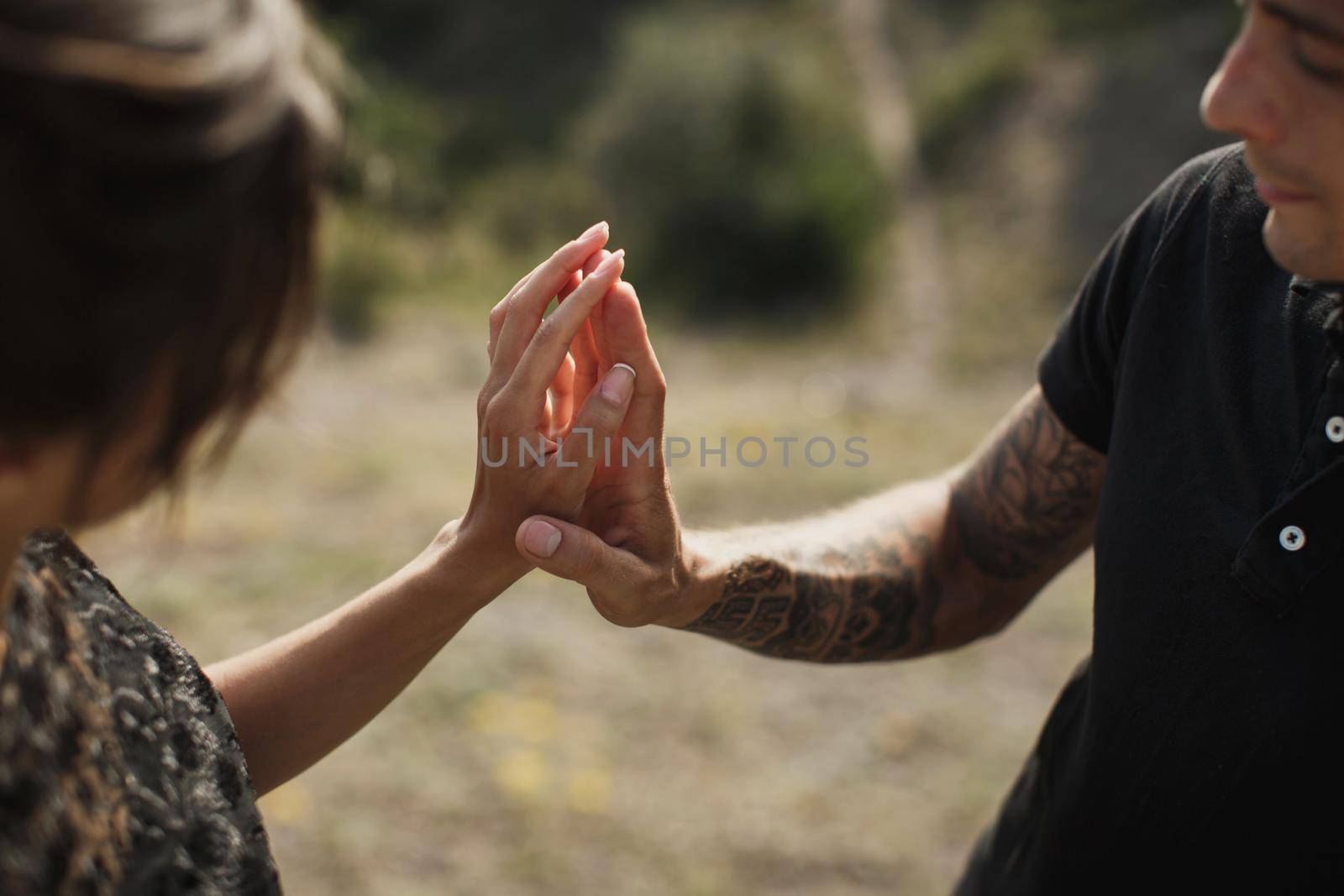 Woman and man in black clothes outdoors. Black wedding dress. by StudioPeace