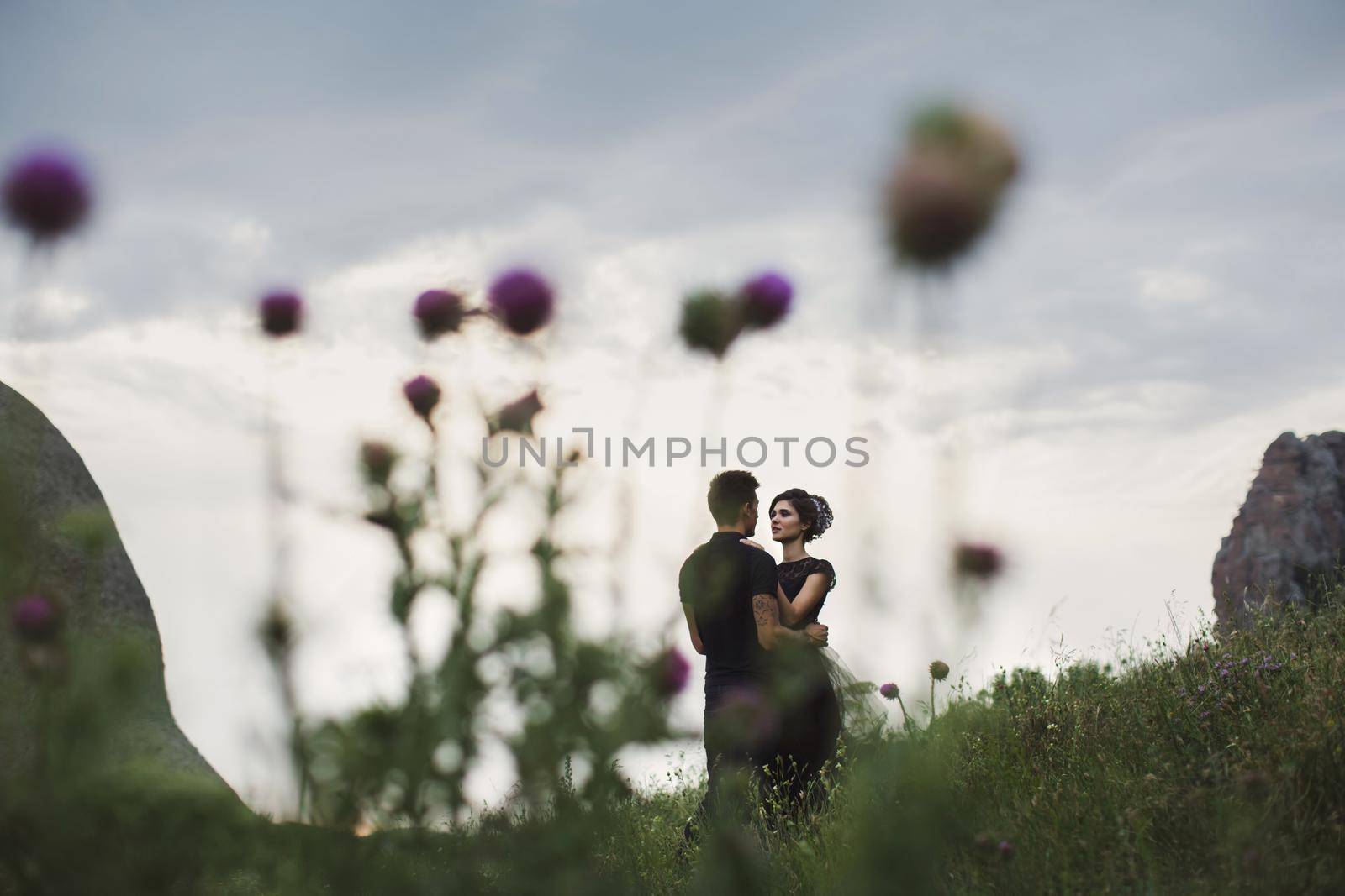 Woman and man in black clothes outdoors. Black wedding dress. by StudioPeace