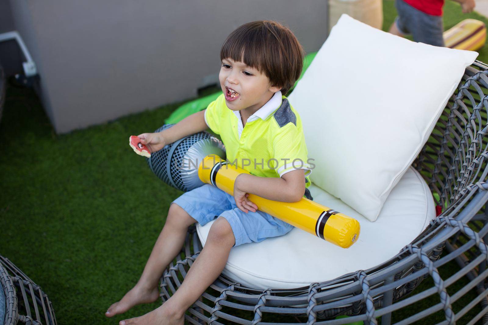 Boy with inflatable microphone at a children's birthday party.