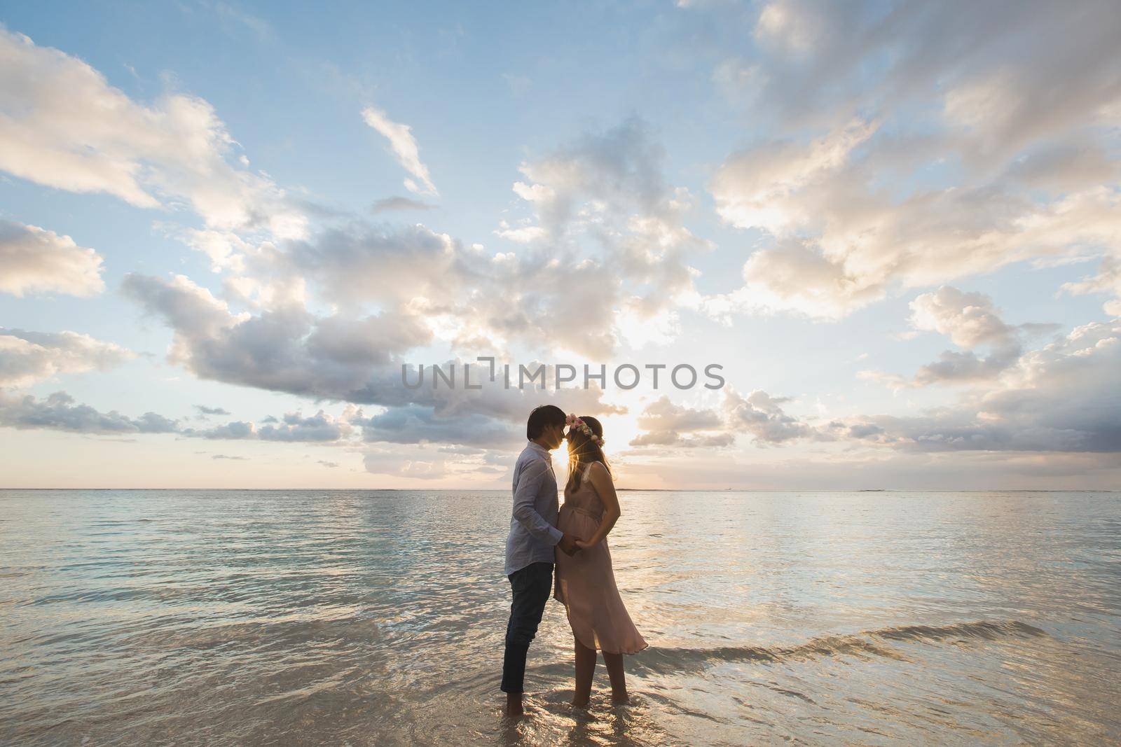 Beautiful pregnant girl and man at sunset. by StudioPeace