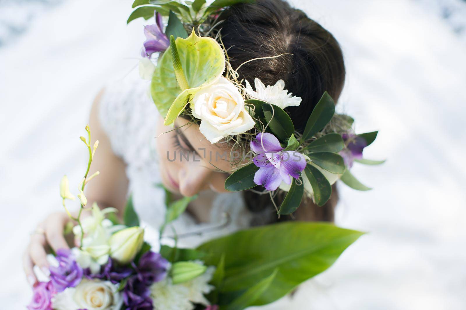 Beautiful young bride in a wreath with a bouquet in hand. by StudioPeace