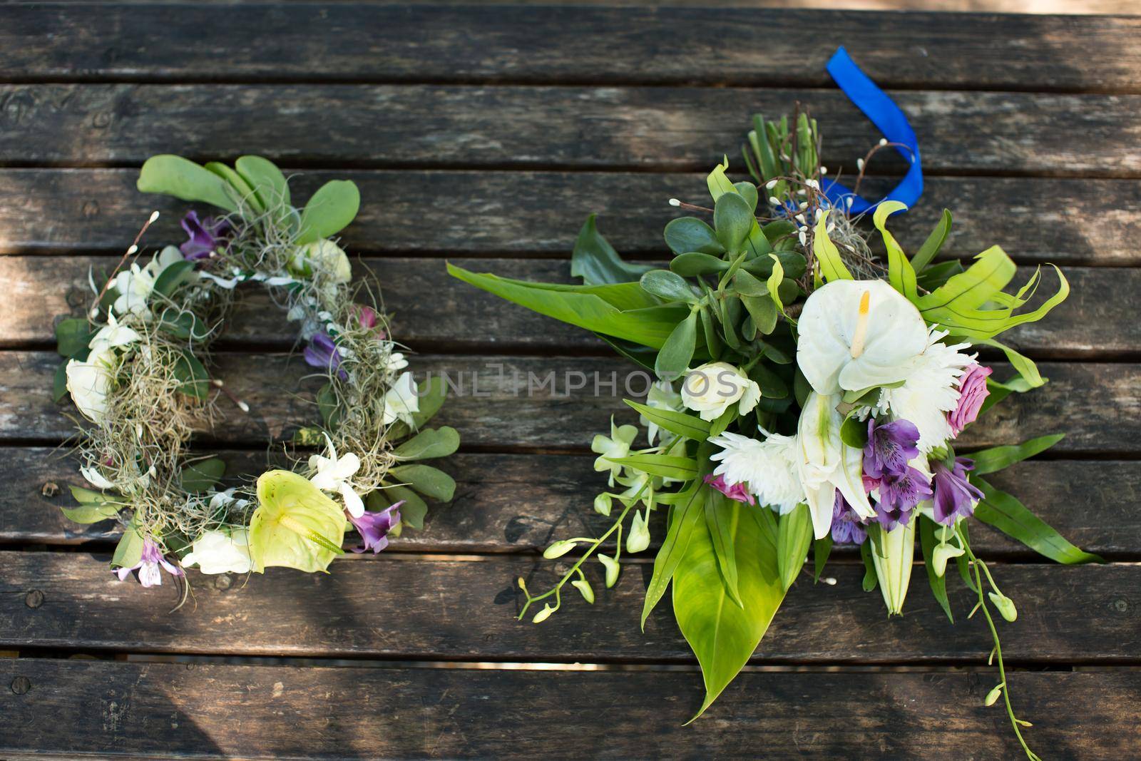 wedding bouquet and wreath on a wooden table