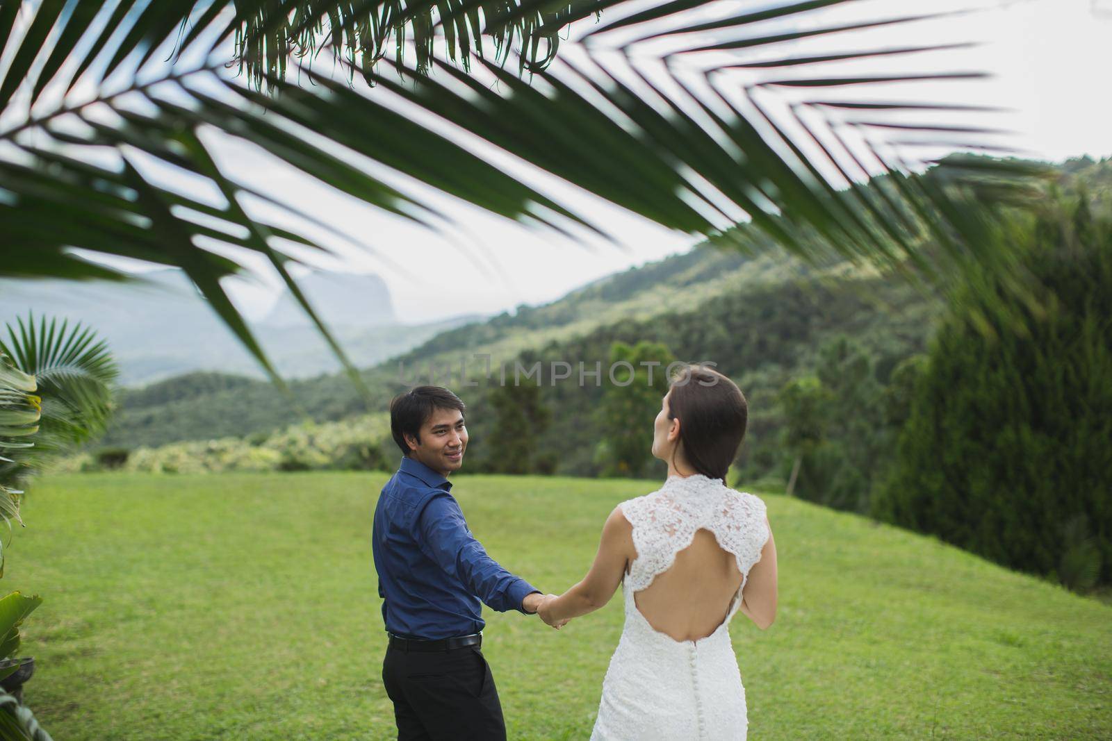 young loving happy couple on tropical island with palm trees