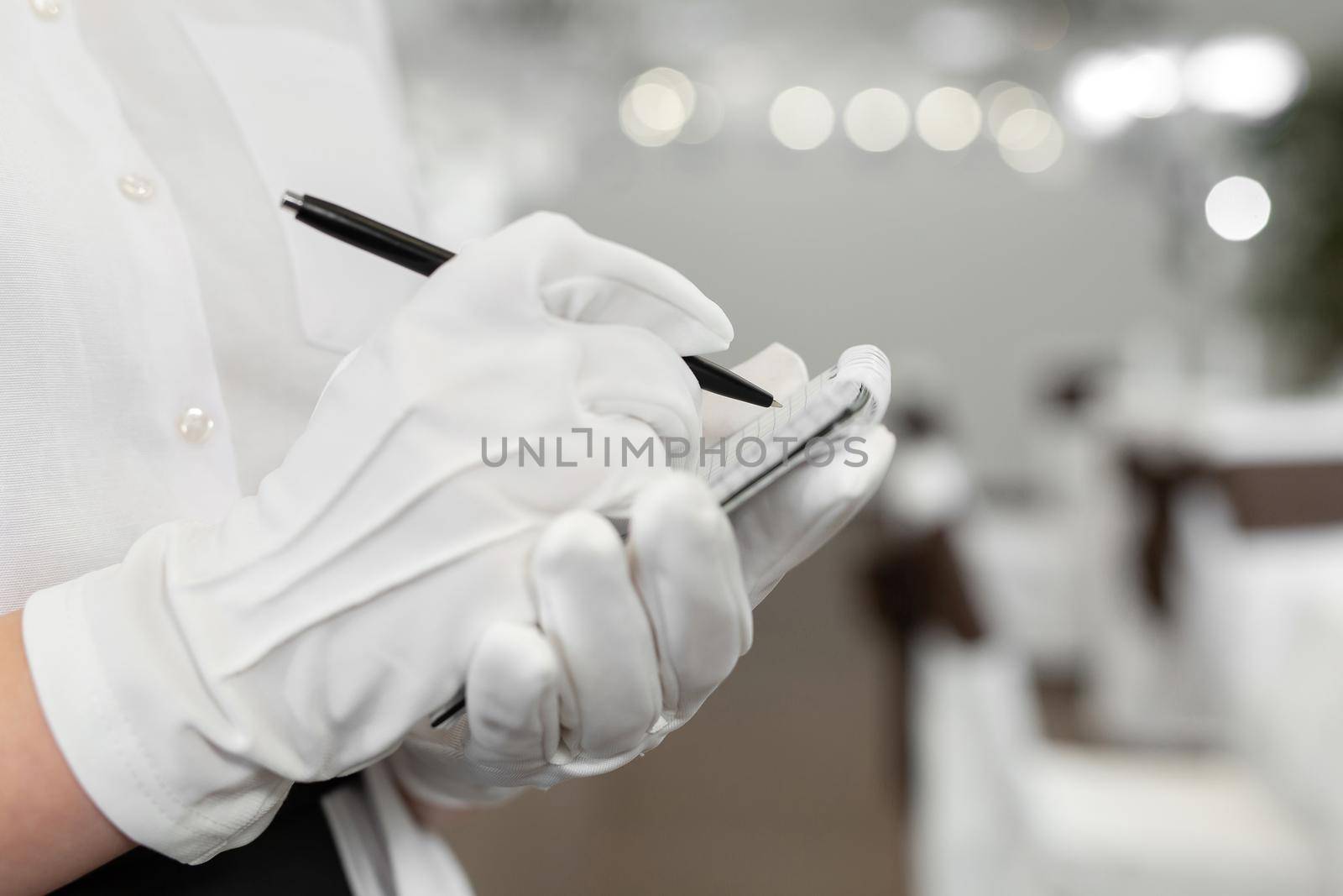 Waiter writing an order into a notebook