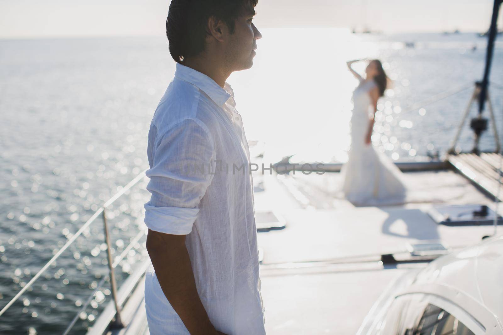 Just married couple on yacht. Happy bride and groom. by StudioPeace