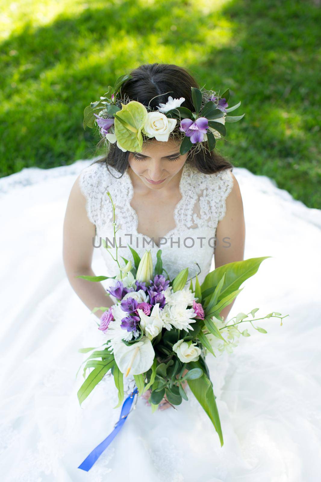 Beautiful young bride in a wreath with a bouquet in hand