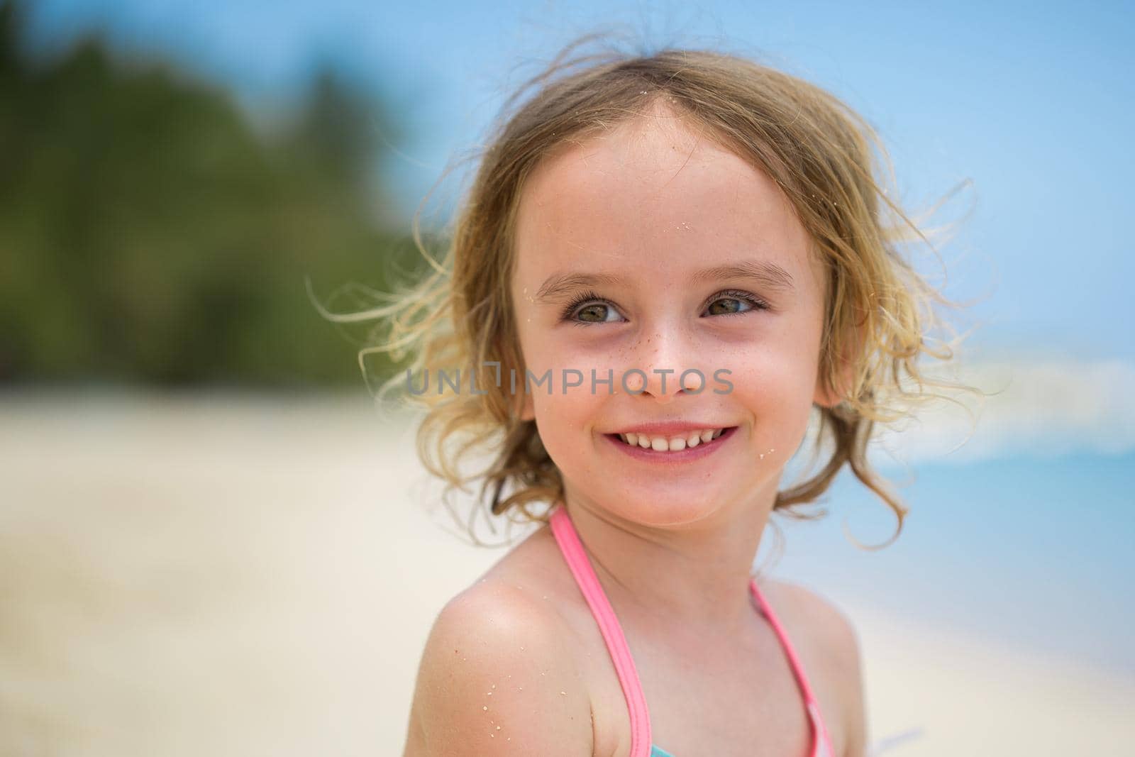 Portrait of adorable little girl at beach during summer vacation