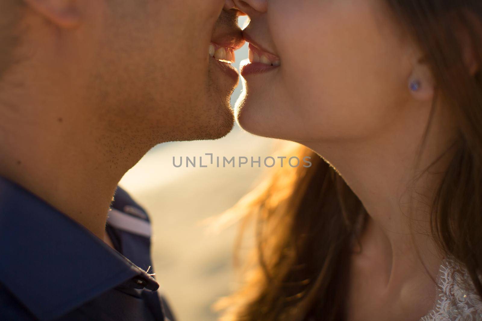 Bride and groom kisses tenderly. Sexy kissing stylish couple of lovers close up portrait. by StudioPeace