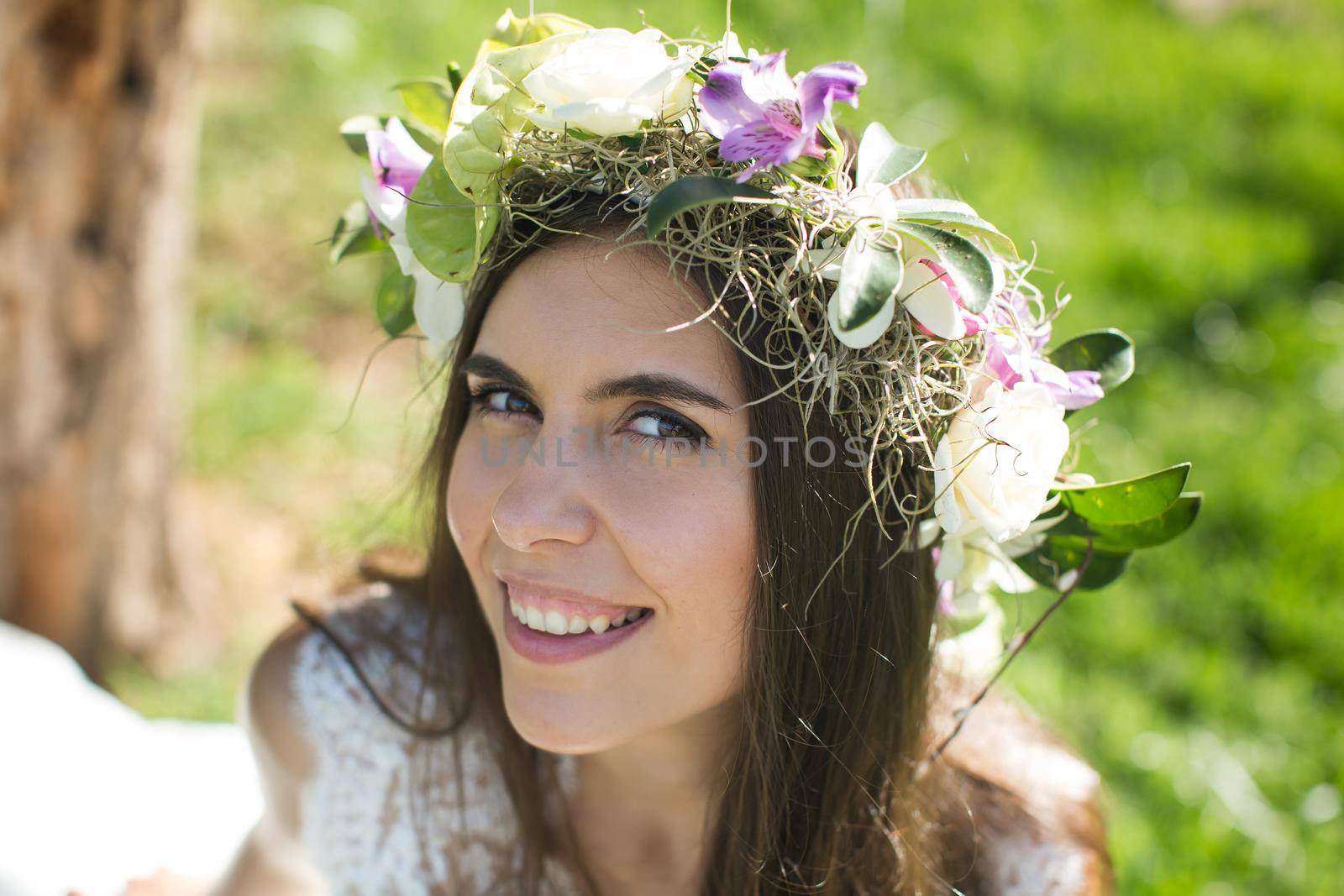 Beautiful young bride in a wreath with a bouquet in hand. by StudioPeace