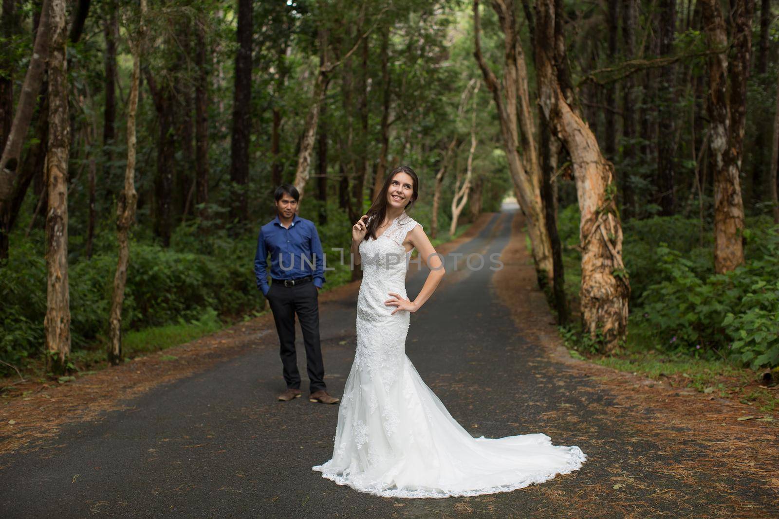 Walking the young bride and groom in the woods