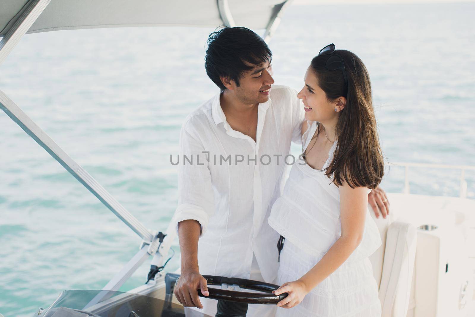 Young couple navigating on a yacht in Indian ocean