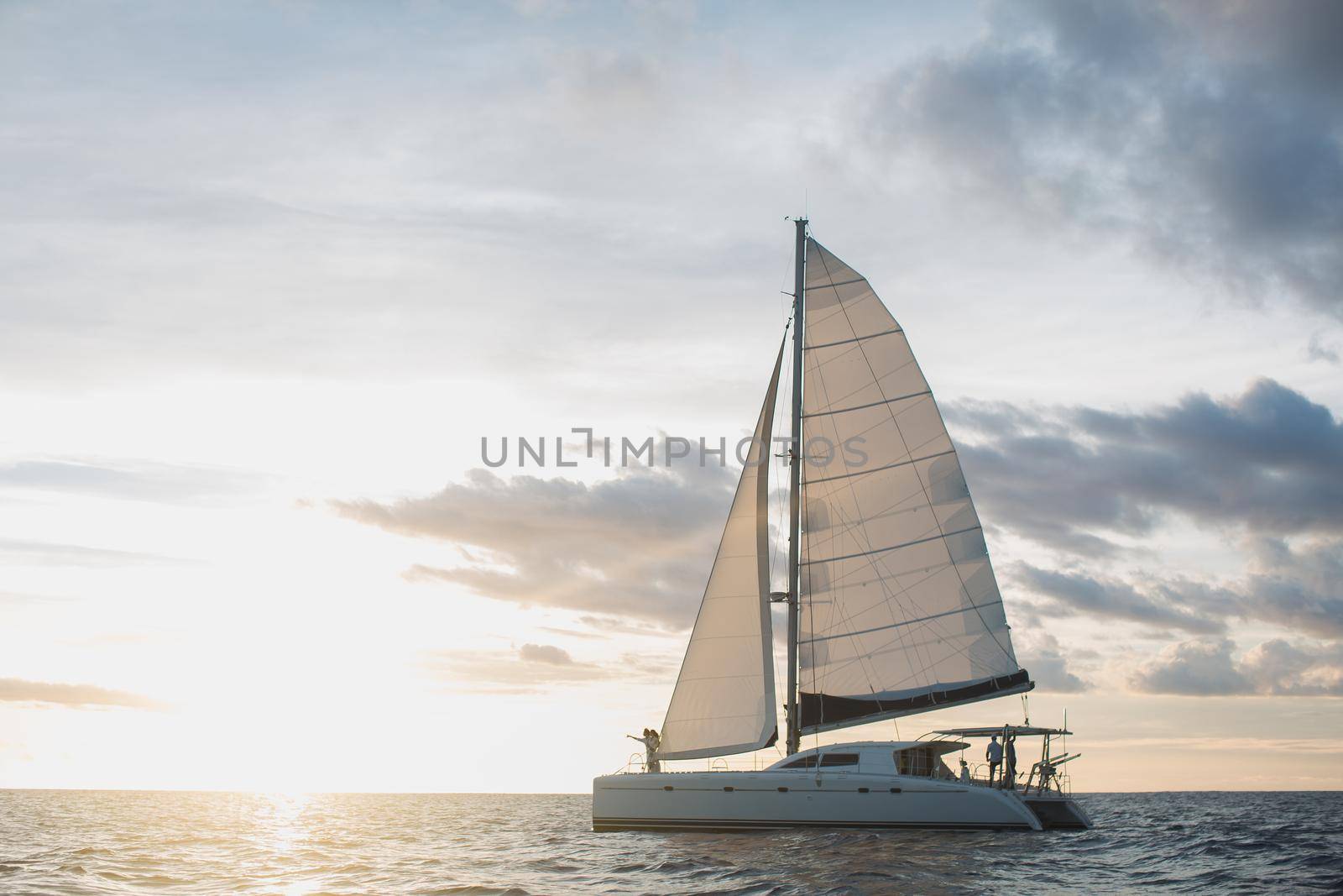 Wedding couple is hugging on a yacht. Beauty bride with groom.