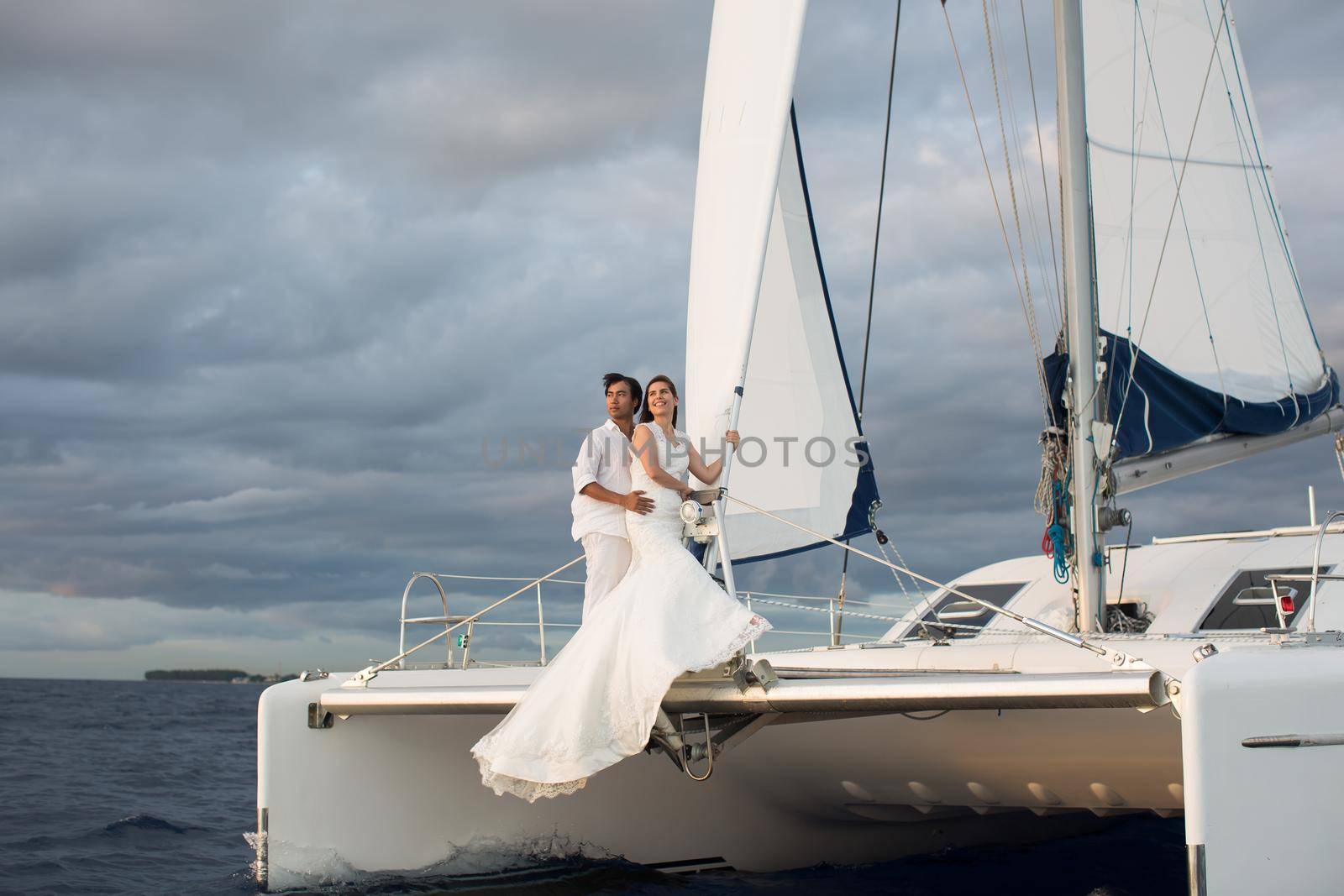 Wedding couple is hugging on a yacht. Beauty bride with groom by StudioPeace