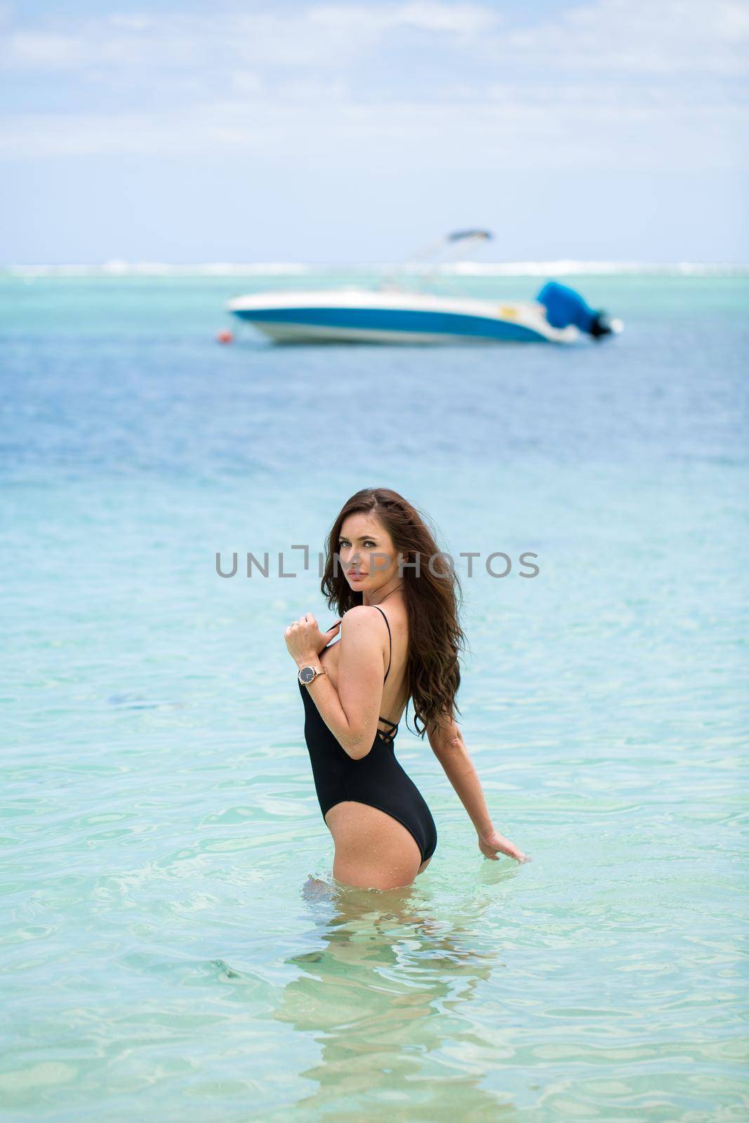 Sexy beach model woman having fun swimming in ocean