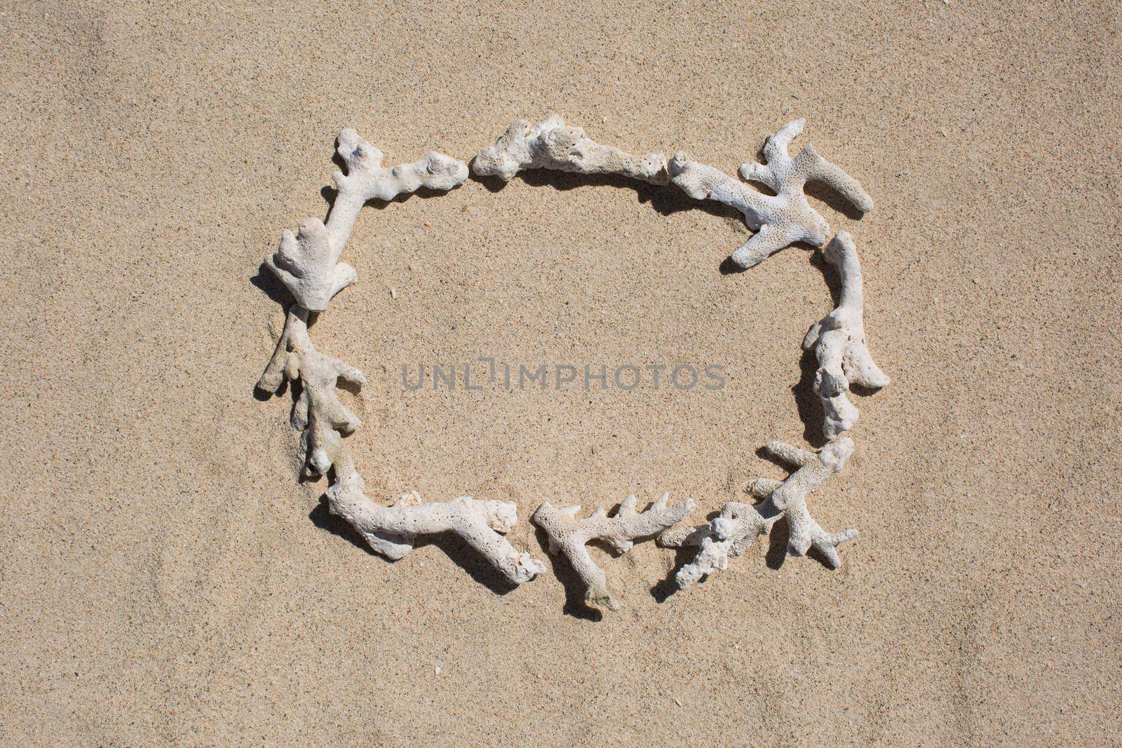 Frame of inscription of coral debris on the sand.