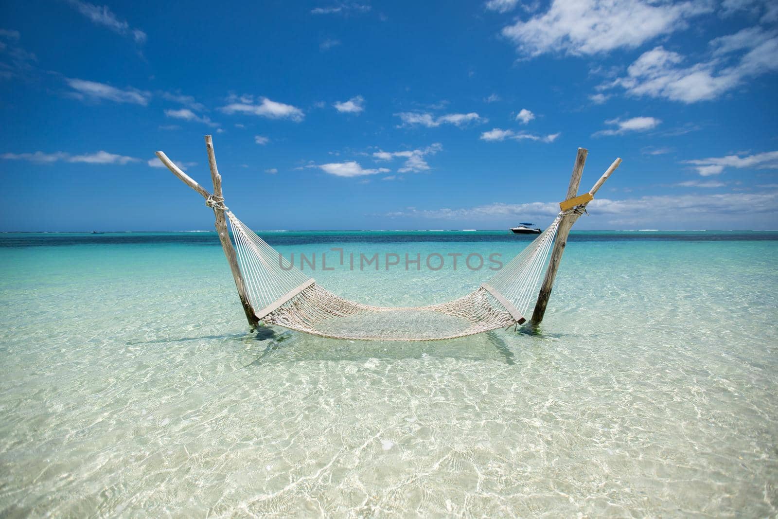 Empty over-water hammock in the middle of tropical lagoon. by StudioPeace