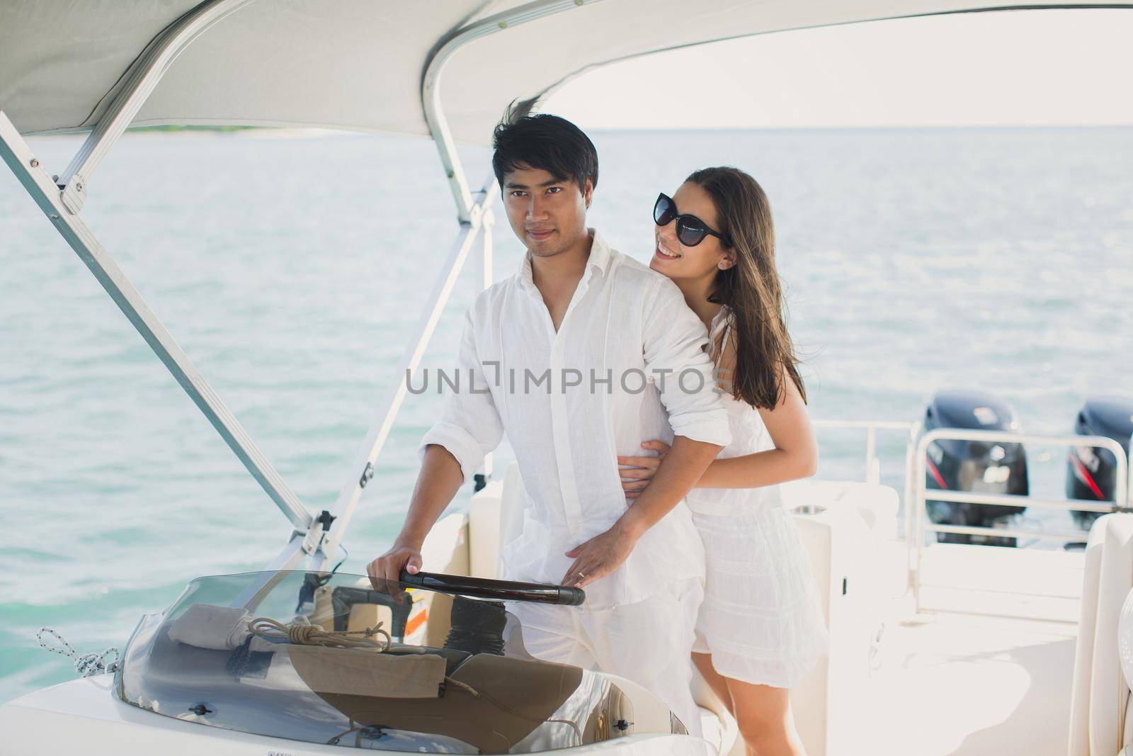 Young couple navigating on a yacht in Indian ocean