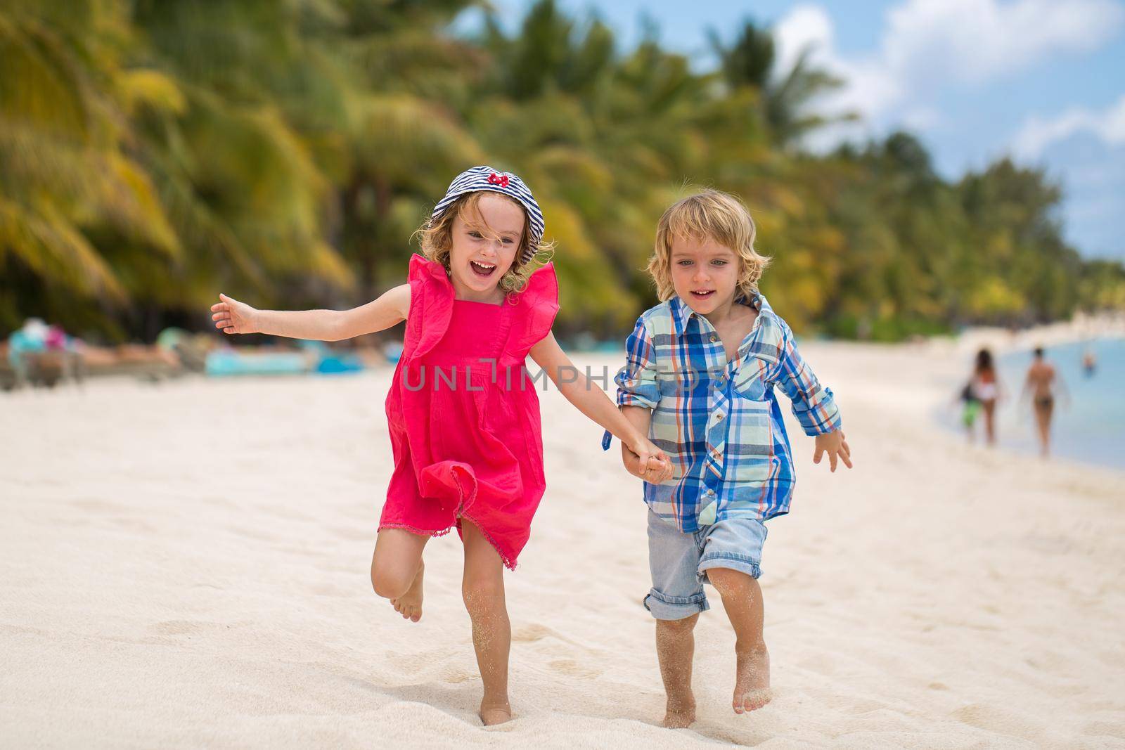 kids having fun running together in the beach