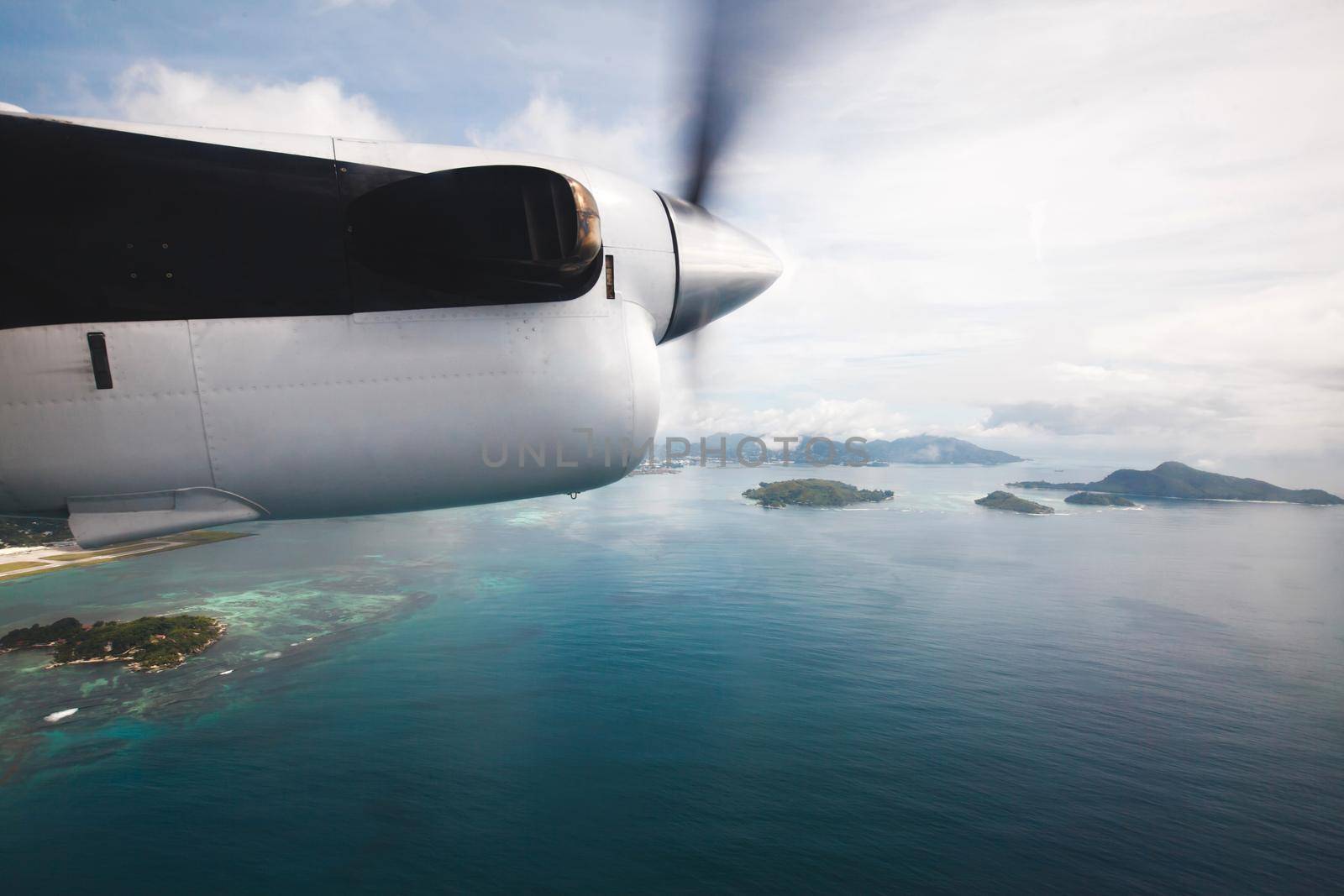 Passenger airliner flies over the Indian ocean. Seychelles.