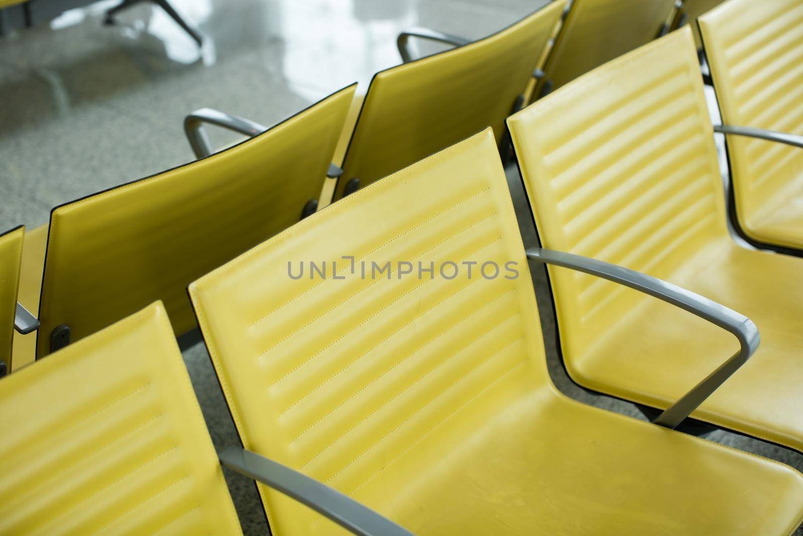 Bench in the terminal of airport. empty airport terminal waiting area with chairs by StudioPeace