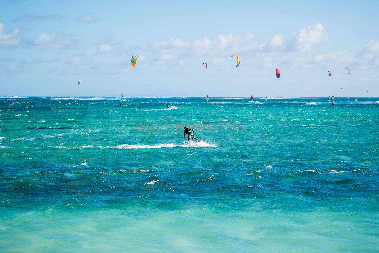 Kitesurfers on the Le Morne beach in Mauritius. by StudioPeace