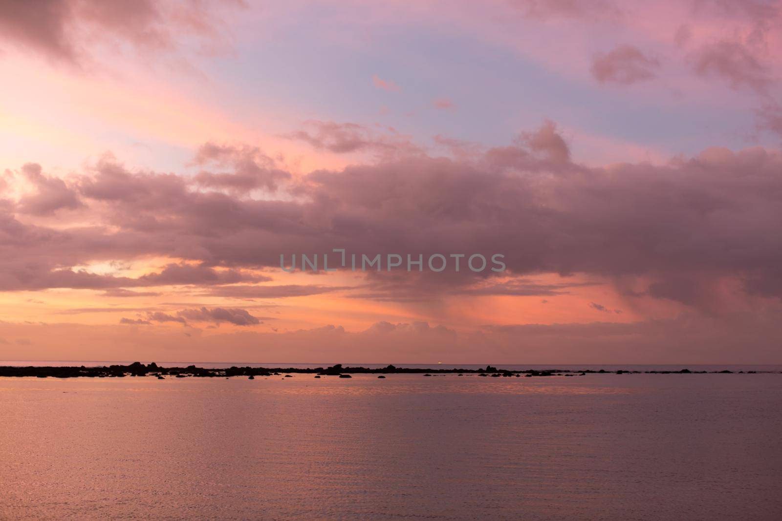 Aerial panoramic view of sunset over ocean.