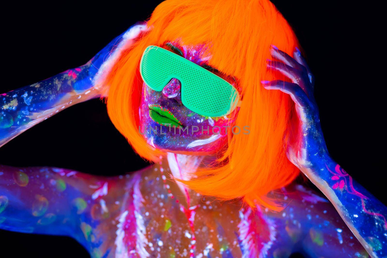 Disco dancer in neon light. Fashion model woman in neon light, portrait of beautiful model girl with fluorescent make-up, Body Art design in UV, painted face, colorful make up, over black background. by StudioPeace