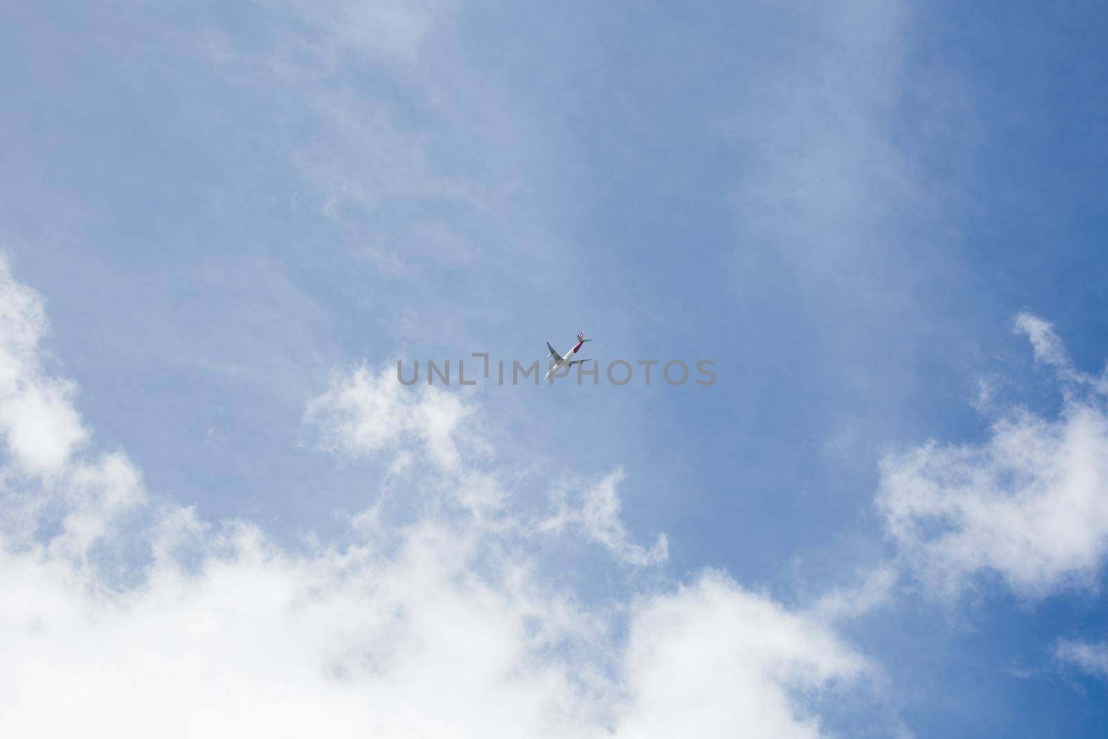 Plane in flight against the blue sky by StudioPeace