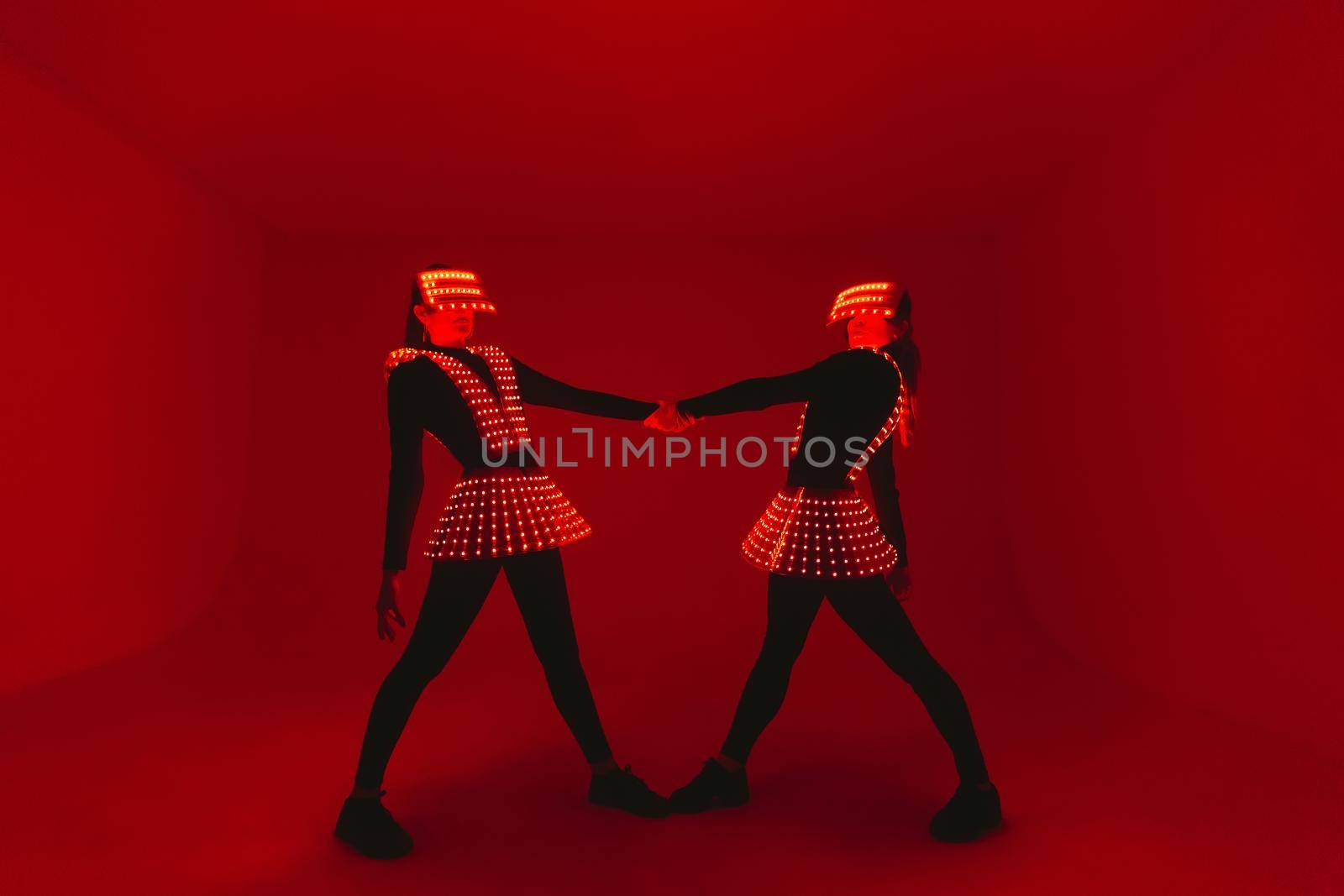 Two disco dancers move in UV costumes.