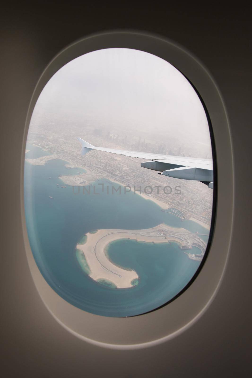 The plane-the view from the window of the porthole on the city Arab Emirates Dubai. by StudioPeace