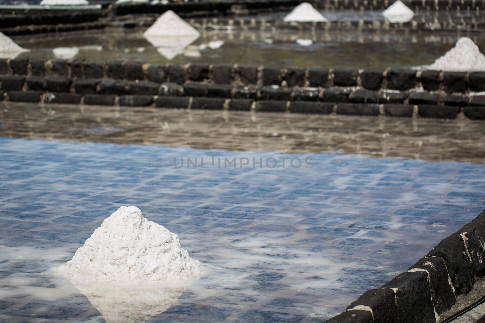 Fields of salt on the shores of the Indian ocean in Mauritius. The collection of salt.