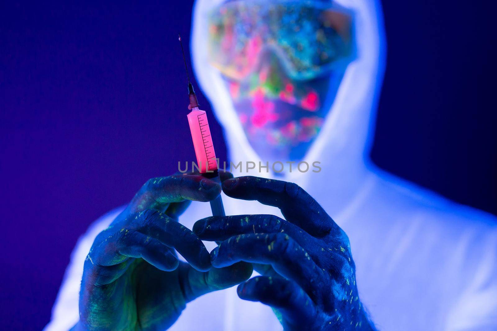 Doctor in ultraviolet neon light is holding COVID-19, oronavirus vaccine and syringe using for prevent infection. Medicine and Healthcare concept. by StudioPeace