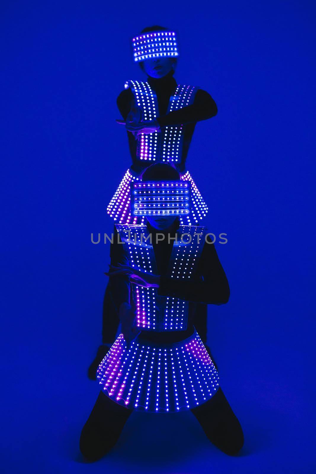 Two disco dancers move in UV costumes.