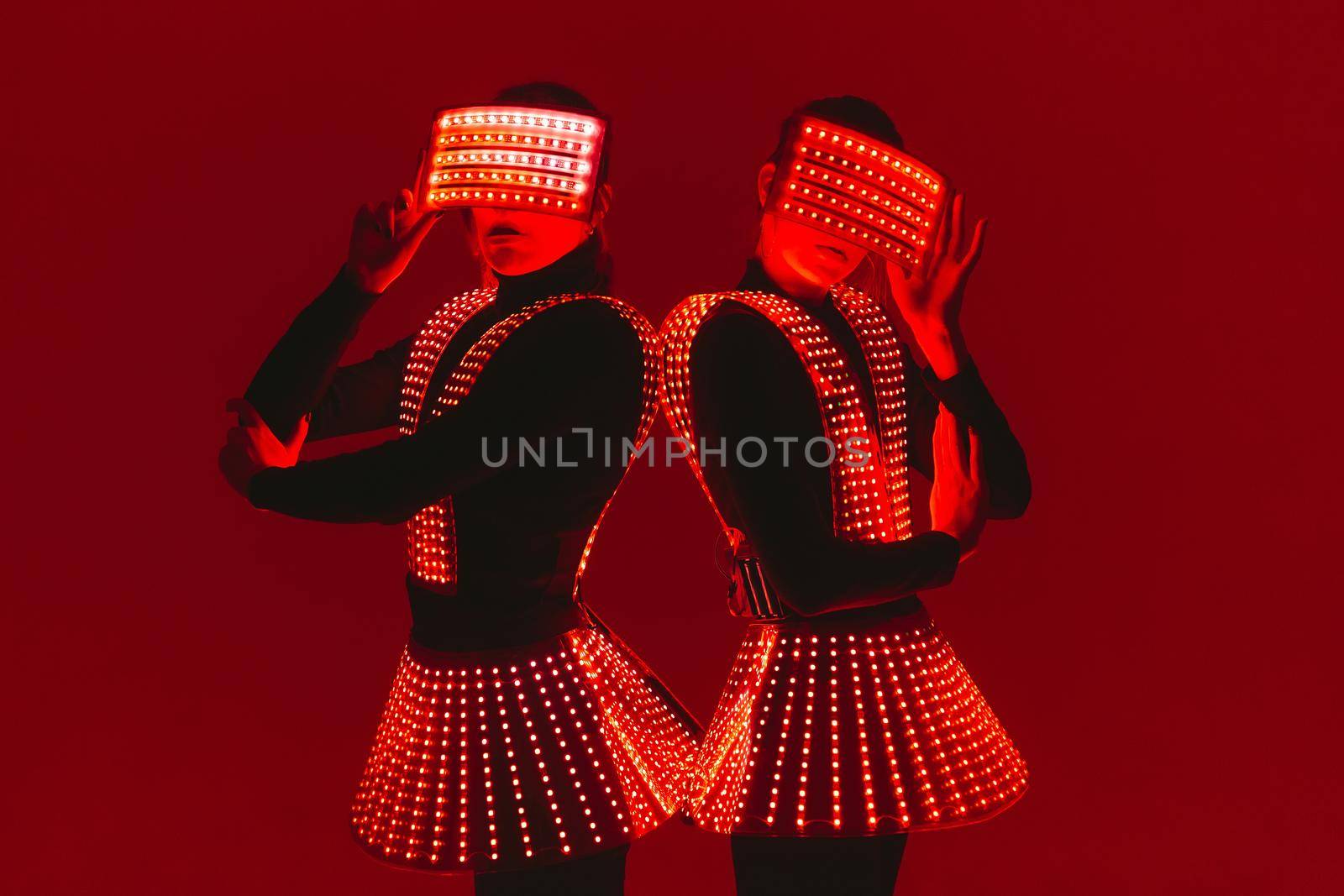 Two disco dancers move in UV costumes.