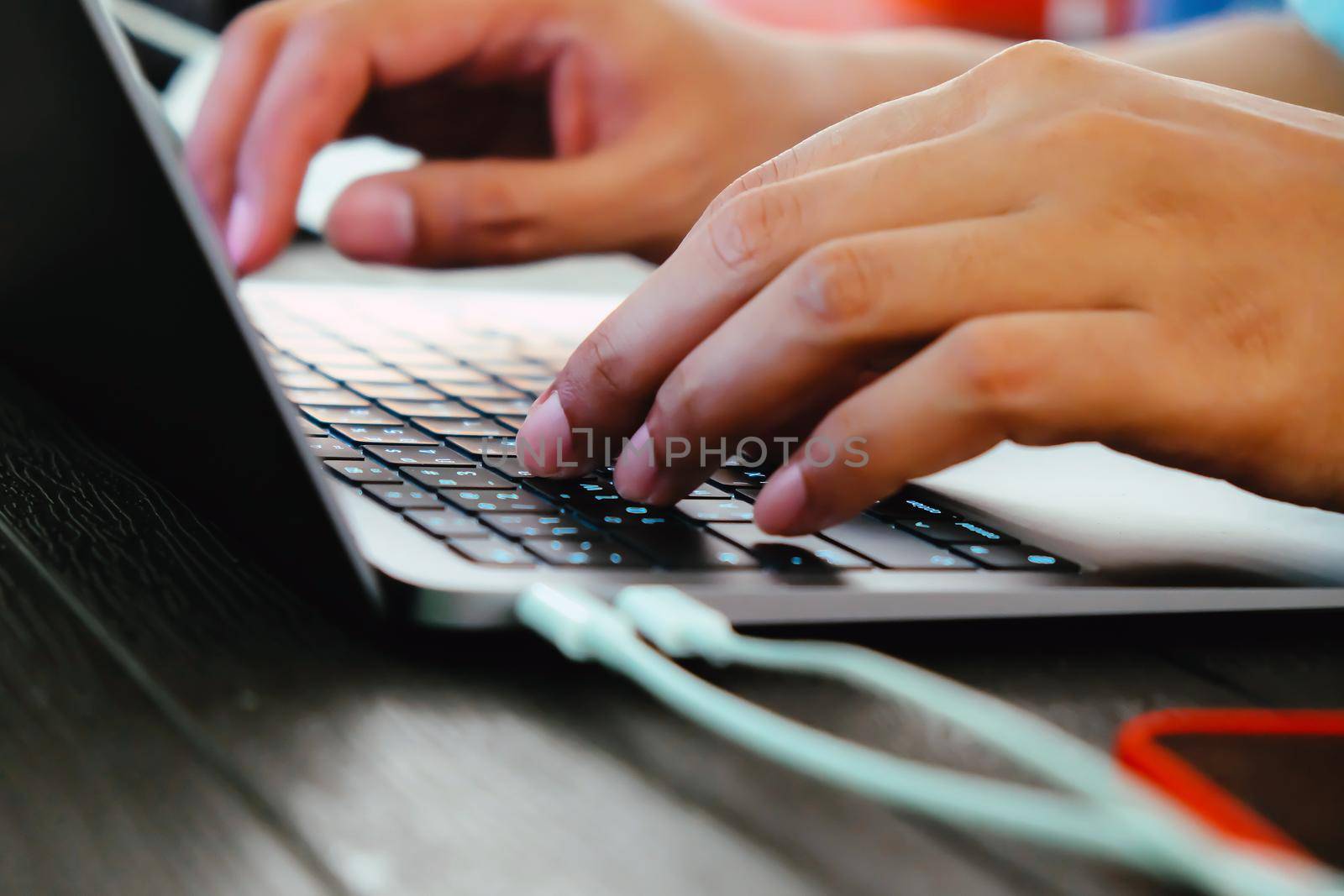 hands of businessman typing on laptop keyboard by ponsulak