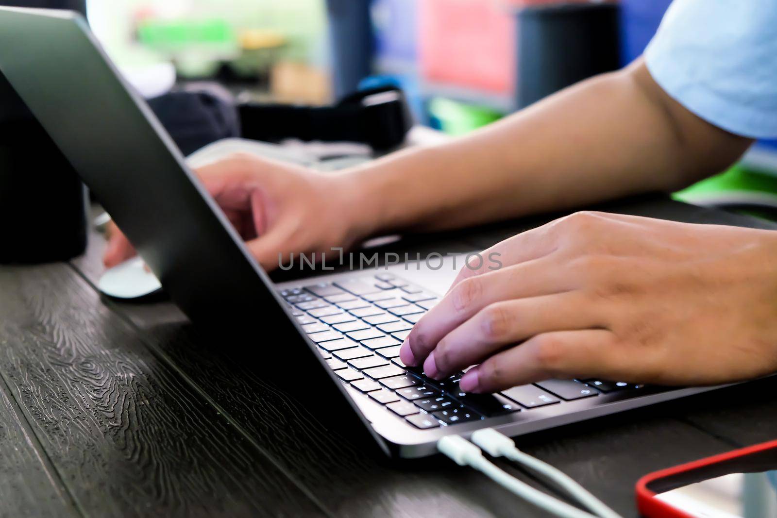 hands of businessman typing on laptop keyboard by ponsulak